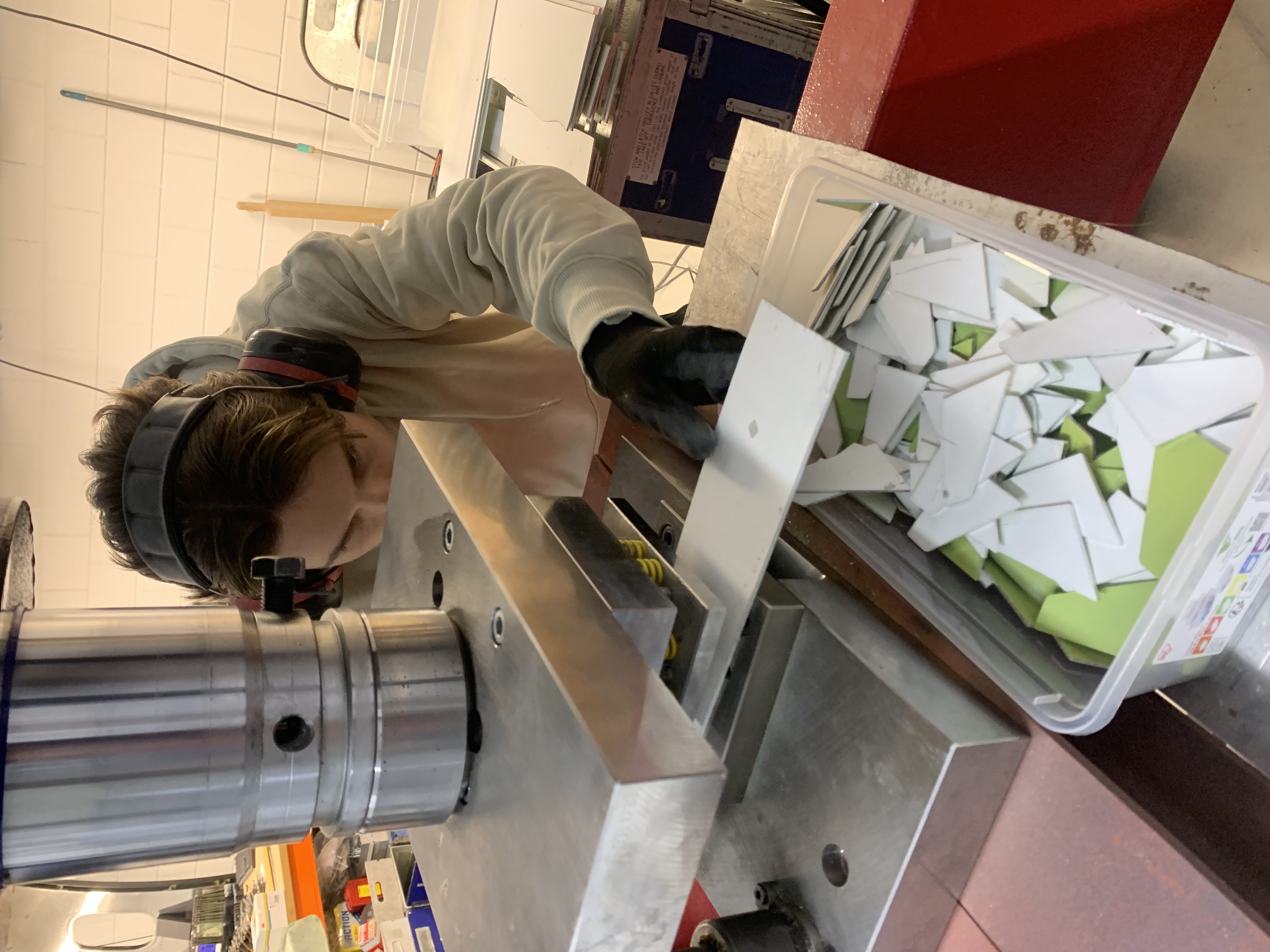 Handling a stripped fuselage skin section in the workshop